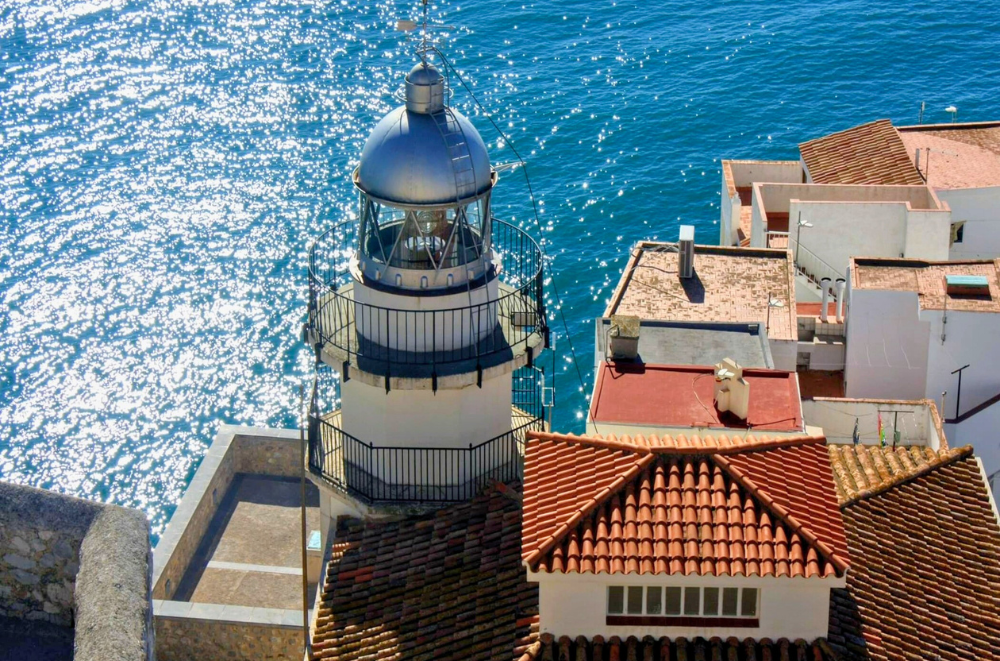 Peñíscola lighthouse overlooking tiled roofs and the Mediterranean sea