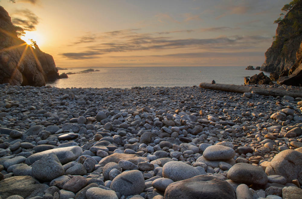 Sunset over the pebble beach in Cala Pedrosa. Although it has no sand, it's still considered as one of the best beaches in Costa Brava