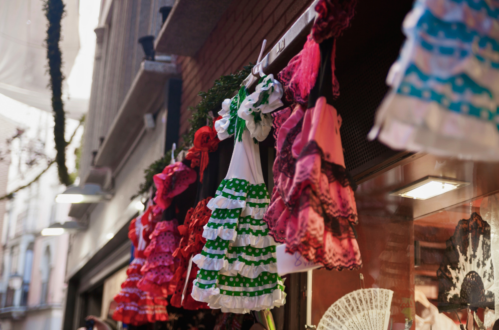Colorful flamenco dresses on display in a Spanish shop